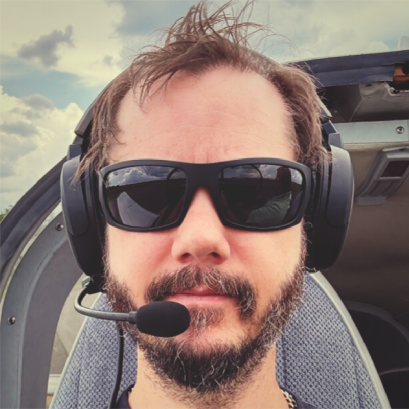 Jeremy Helms wearing sunglasses and an aviation headset